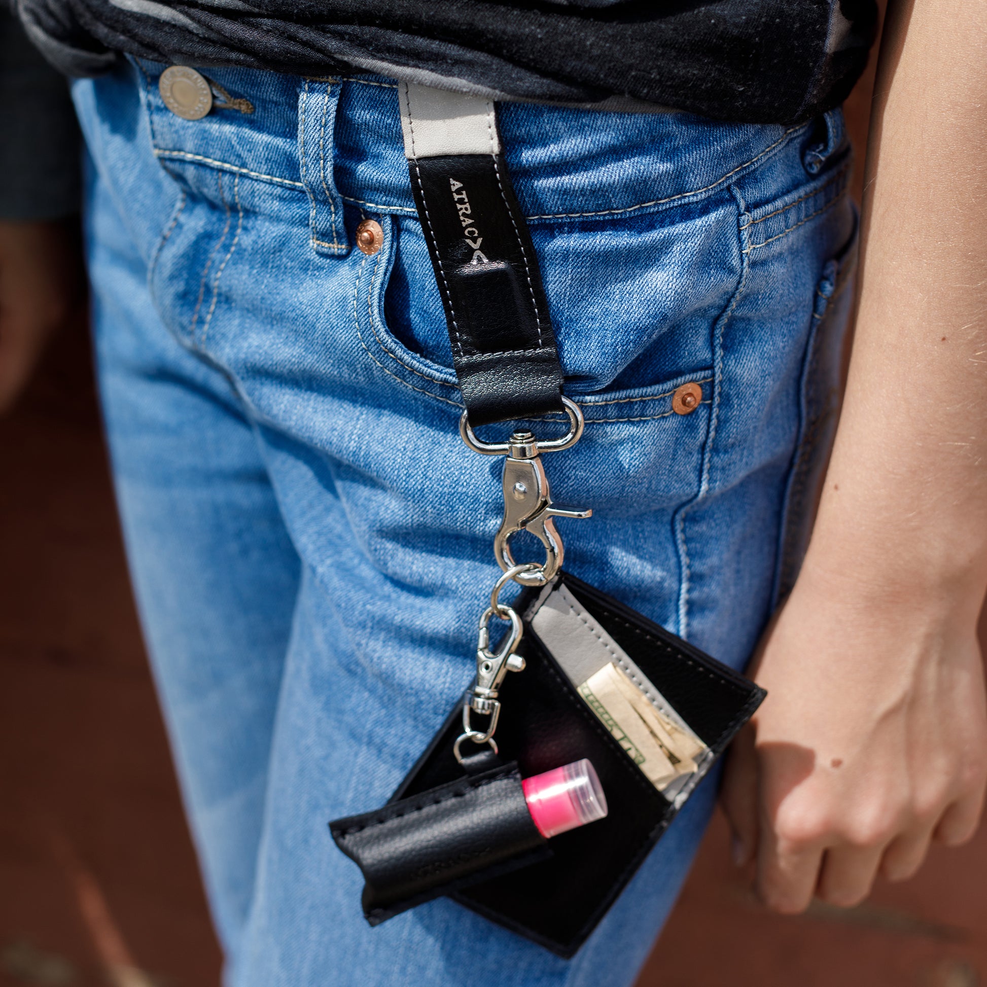 black and gray vegan leather bracelet, keychain, and a three pocket wallet,  with lip balm holder.