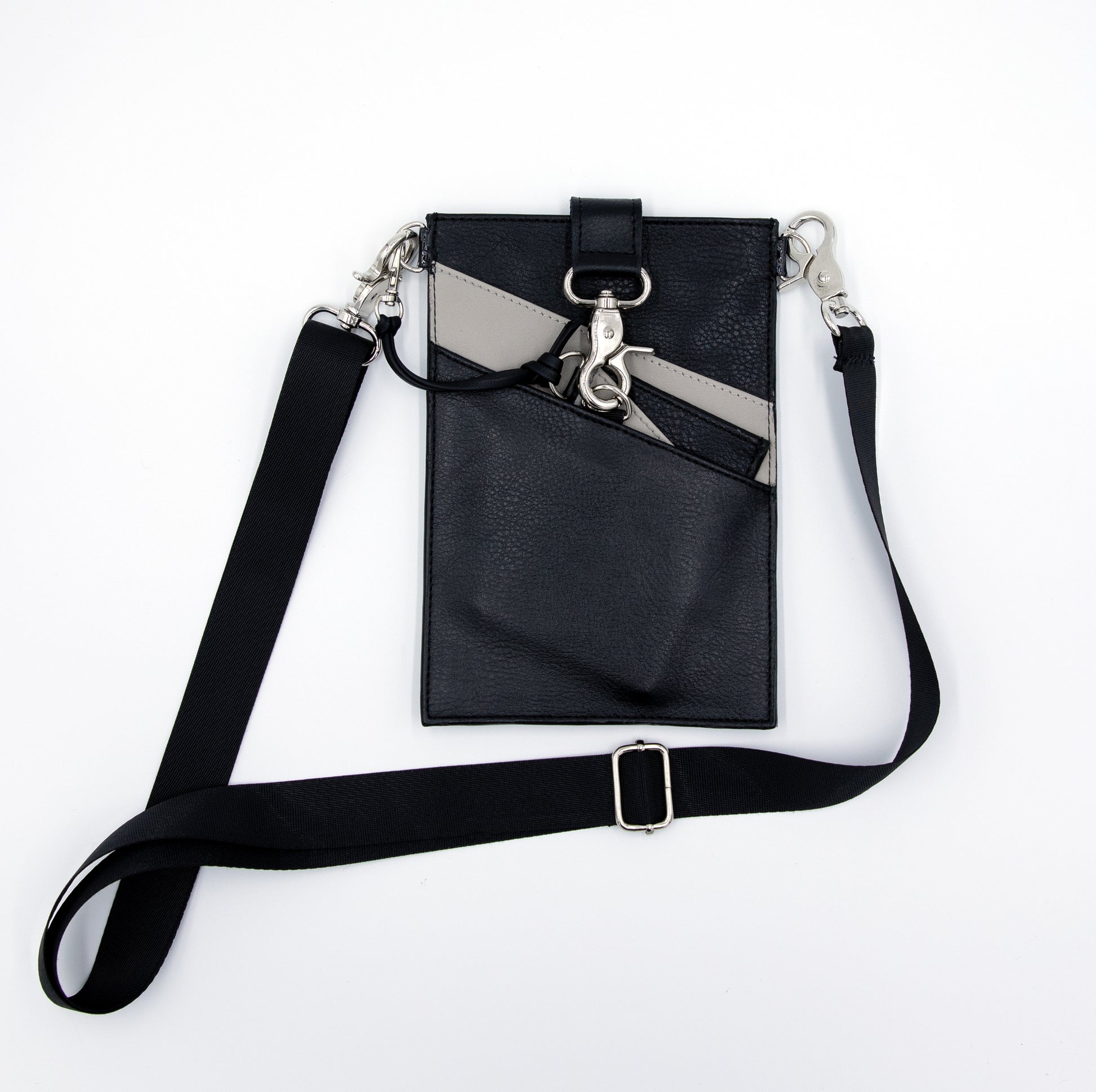 Black and gray vegan leather phone pouch with black cross body strap and a black and gray three pocket wallet.